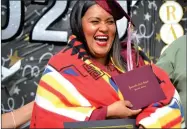  ??  ?? Aissa Arriaga was overjoyed to receive her diploma at the Portervill­e Adult School drive-thru graduation ceremony on Monday morning.