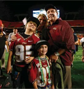  ?? GETTY IMAGES ?? Then-head coach Jimbo Fisher of Florida State poses with his wife, Candi, and sons Trey (left) and Ethan after the Seminoles beat Northern Illinois on Jan. 1, 2013.