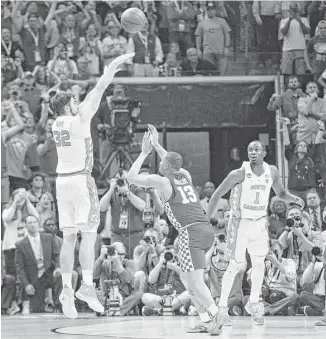  ?? Brandon Dill / Associated Press ?? North Carolina forward Luke Maye (32) gets off the winning shot before Kentucky’s Isaiah Briscoe (13) can get close enough to try to stop him Sunday at the South Regional final in Memphis, Tenn.