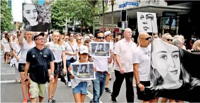  ??  ?? People walk in a silent march to remember Grace Millane in Auckland, New Zealand, in December 2018