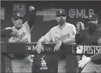  ?? RONALD MARTINEZ/GETTY ?? Dodgers manager Dave Roberts, left, on his team’s offensive versatilit­y in the postseason: “We have to understand what we can do that night.”