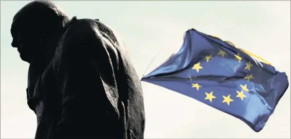  ?? PHOTO: BLOOMBERG ?? A European Union (EU) flag flies near to a statue of Winston Churchill, former British prime minister, during a Unite for Europe march to protest Brexit in central London, last Saturday. UK Prime Minister Theresa May is ready to officially start the...