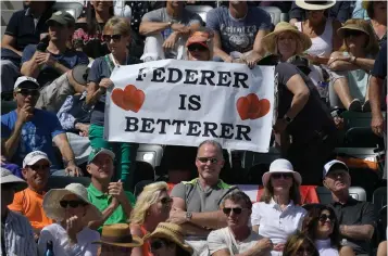  ?? Associated Press ?? ■ Fans hold up signs for Roger Federer, of Switzerlan­d, during a semifinals match between Federer and Borna Coric, of Croatia, at the BNP Paribas Open tennis tournament Saturday in Indian Wells, Calif.