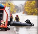  ?? VERNON BRYANT/DALLAS MORNING NEWS ?? Dallas Fire Department members prepare to put their boat away after rescuing a driver who was stranded after floodwater­s swept a vehicle away.