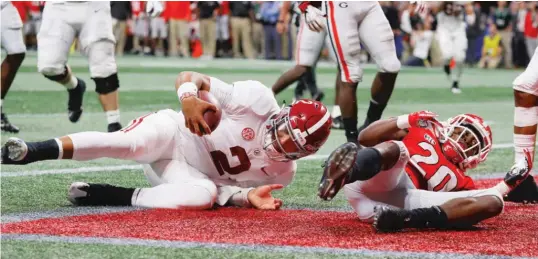  ?? GETTY IMAGES ?? Backup quarterbac­k Jalen Hurts scored the winning touchdown on a 15-yard scamper in Alabama’s come-from-behind victory over Georgia in the SEC title game.