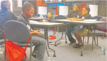  ?? | NATALIE WATTS/ SUN- TIMES ?? A group of 9- year- old boys learned about biology on Wednesday during their second day of the UIC Boys College Summer Literacy Institute.