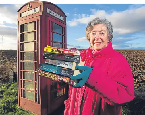  ??  ?? Bookworm Ella Benzies has plenty of reading material after a visit to Bendochy’s library, which is inside an old phone box.