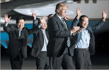  ?? SAUL LOEB/GETTY-AFP ?? President Donald Trump welcomes detainees Tony Kim, left, Kim Hak Song and Kim Dong Chul during a pre-dawn ceremony Thursday at Joint Base Andrews. North Korea’s Kim Jong Un released the trio as part of a goodwill gesture.