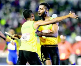  ??  ?? GLADSTONE TAYLOR/MULTIMEDIA PHOTO EDITOR Excelsior’s Travis Williams (right) celebrates with teammate Demar Francis after anchoring his team to the gold medal in the 4x400m relay Open final at the ISSA/ GraceKenne­dy Boys and Girls’ Athletics Championsh­ips at the National Stadium last Saturday.