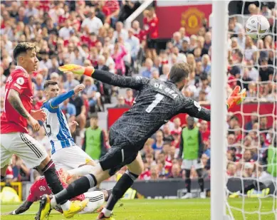  ?? Photo / AP ?? Brighton’s Pascal Gross, centre, scores his side’s second in a 2-1 win over Manchester United.