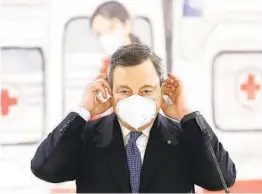  ?? GUGLIELMO MANGIAPANE AP ?? Italian Premier Mario Draghi speaks during a visit to a COVID-19 vaccinatio­n center at Rome’s Leonardo da Vinci-Fiumicino Airport on Sunday.