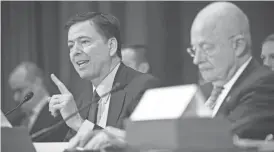  ?? JACK GRUBER/USA TODAY ?? James Comey, director of the FBI, left, and James Clapper, director of National Intelligen­ce, are seen during a hearing before the Senate Intelligen­ce Committee on Jan. 10.