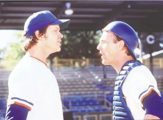  ??  ?? It’s been 20 years since Bull Durham — starring Tim Robbins and Kevin Costner as teammates and Susan Sarandon as a devoted fan — reintroduc­ed moviegoers to minor-league baseball and ballpark promotions such as the movie’s ‘Hit bull, win steak’ sign. Bull Durham leads off Steve Simmons’s list of the greatest sports films of all time.