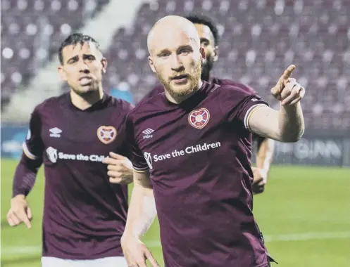  ??  ?? 0 Hearts striker Liam Boyce celebrates after scoring from the penalty spot to put his side 3- 1 up against Dundee at Tynecastle Park.