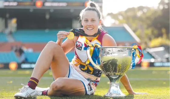  ?? Picture: AFL Photos ?? Lions great Emma Zielke with the premiershi­p trophy after her side beat the Crows in this year’s grand final at Adelaide Oval.