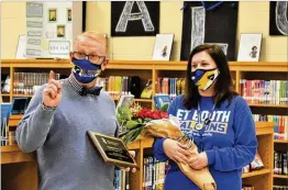  ?? COURTESY PHOTOS ?? Cherokee County Superinten­dent of Schools Brian V. Hightower congratula­tes E.T. Booth Middle School media specialist Amanda Graves on earning the title of CCSD’S 2021 Media Specialist of the Year.