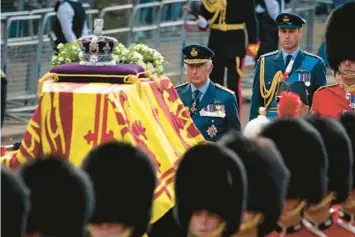  ?? AARON CHOWN/POOL PHOTO ?? King Charles III and Prince William follow Queen Elizabeth II’s coffin Wednesday to Westminste­r Hall.