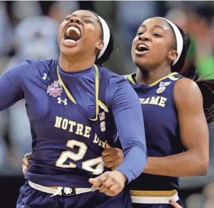  ??  ?? Arike Ogunbowale is congratula­ted by teammate Jackie Young after sinking the winning three-pointer