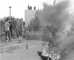  ??  ?? Israeli settlers burn tyres to protest against the evacuation of homes at Netiv Haavot settlement near Bethlehem, in the occupied West Bank. — AFP photo