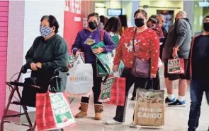  ?? RINGO H.W. CHIU/AP ?? Black Friday shoppers wait in line to enter a store at the Glendale Galleria in Glendale, California, in 2020. Black Friday has lost momentum during the pandemic.