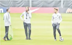  ?? — AFP photo ?? England manager Gareth Southgate (C) makes a phone call before a training session at The Grove Hotel in Watford, north of London on June 1, 2018 on the eve of their friendly football match against Nigeria.