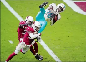  ?? ROSS D. FRANKLIN/AP PHOTO ?? Miami Dolphins wide receiver Preston Williams (18) pulls in a touchdown catch as Arizona Cardinals free safety Jalen Thompson (34) defends during the first half of Sunday’s game in Glendale, Ariz. The Dolphins won 34-31.