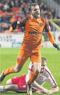  ?? Picture: SNS Group. ?? Paul McMullan goes down after a Gary Fusco challenge to earn a second yellow card and a sending-off.