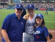  ?? Photo courtesy Karlie Habitz ?? Karlie Habitz, a former Valencia softball catcher and current Dodgers ball girl, with her uncle Tom Nussbaum, left, and sister Corinna Habitz, right, caught a foul ball with an exit velocity of 101 mph on Saturday, June 15, in the Dodgers’ game against the Cubs.