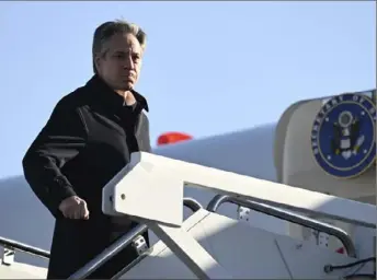  ?? Andrew Caballero-Reynolds/Pool via AP ?? Secretary of State Antony Blinken boards a plane Monday at Andrews Air Force Base, Md., en route to Kingston, Jamaica, for emergency talks with Caribbean leaders on Haiti’s crisis.