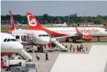  ?? — Reuters ?? Passengers board an Air Berlin aircraft at Tegel airport in Berlin, Germany.