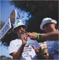  ?? (Tomer Neuberg/Flash90) ?? ACTIVISTS IN Tel Aviv’s Rabin Square mark ‘4/20’ during a demonstrat­ion calling to legalize marijuana.