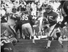  ?? ASSOCITED PRESS FILE PHOTO ?? Denver quarterbac­k Marlin Briscoe, right, passes the ball during an American Football League game 50 years ago.
