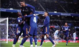  ?? Photograph: Ricardo Larreina/Shuttersto­ck ?? Luka Jovic (top) is mobbed by his Real Madrid teammates after scoring the second goal in the 2-0 win at Real Sociedad.