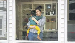  ??  ?? In this Wednesday, April 1, 2020 photo, a pregnant woman holds her son at her home in Cape Elizabeth, Maine.