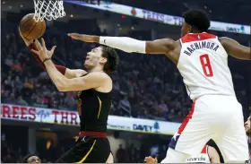  ?? RON SCHWANE — THE ASSOCIATED PRESS ?? Cedi Osman drives against the Wizards’ Rui Hachimura during the first half of the Cavaliers’ victory Feb. 26at Rocket Mortgage FieldHouse.
