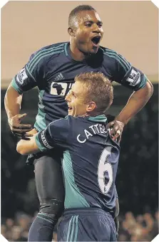  ??  ?? Lee Cattermole hoists Stephane Sessegnon as the Benin star celebrates his magnificen­t, clinching third goal at Craven Cottage.