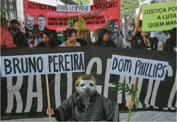  ?? NELSON ALMEIDA /GETTY-AFP ?? Guarani Indigenous people and environmen­tal activists protest Saturday in Sao Paulo, Brazil, over the deaths of British journalist Dom Phillips and Brazilian Indigenous expert Bruno Pereira. Brazil’s federal police said Saturday that a third suspect was arrested. The remains of Phillips and Pereira were discovered on Wednesday.