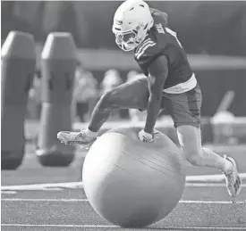  ?? EVERT NELSON/THE CAPITAL JOURNAL FILE ?? Kansas junior running back Devin Neal jumps over an obstacle in a training camp practice earlier in August.