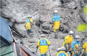  ?? AFP ?? Police search for missing people at the scene of a landslide following days of heavy rain in Atami in Shizuoka Prefecture yesterday.