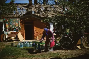  ?? Francisco Seco / Associated Press ?? A woman cleans up outside her damaged house after a Russian strike in Pokrovsk, eastern Ukraine, where Russian forces continue to press their offensive despite fierce resistance.