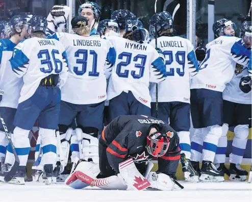  ?? — THE CANADIAN PRESS ?? Canada goalie Michael DiPietro kneels on the ice after Finland’s Toni Utunen beat him with the game-winning shot in overtime at the world junior quarter-final game on Wednesday in Vancouver.