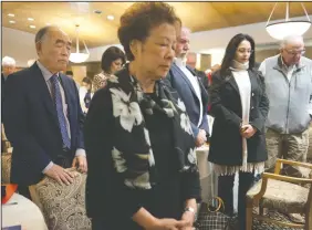  ?? BEA AHBECK/NEWS-SENTINEL ?? Mayor Alan Nakanishi and his wife, Sue, stand during a moment of silence for the victims of Wednesday’s shooting in Thousand Oaks during the mayor’s State of the City breakfast at Woodbridge Golf and Country Club on Thursday.