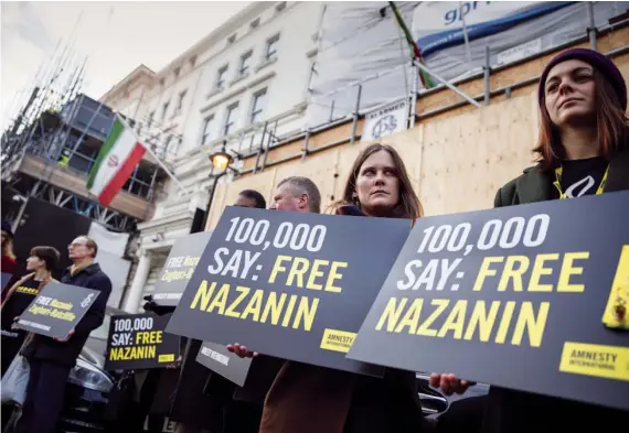  ?? AFP ?? Campaigner­s hold posters demanding the release of jailed Nazanin Zaghari-Ratcliffe in Iran, at the Iranian Embassy in London. Tehran has ordered her to report to court for a new trial.