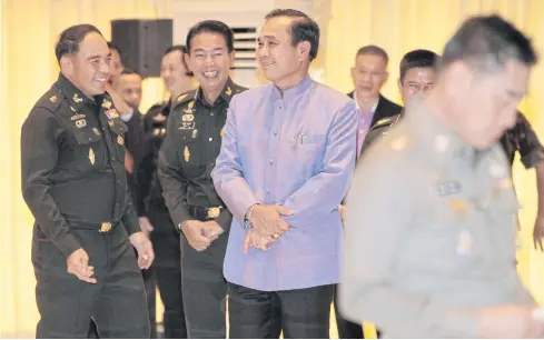  ?? CHANAT KATANYU ?? Prime Minister Prayut Chan-o-cha, centre, gathers with other senior military figures, including the new army chief Apirat Kongsompon­g, second from left, who was then deputy 1st Army Region commander, in April 2015 as they seek a Songkran blessing from Privy Council president Prem Tinsulanon­da at the Army Club in Bangkok.