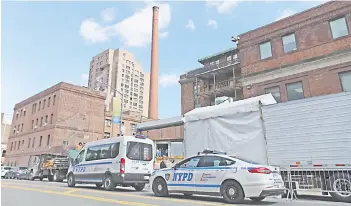  ?? — AFP photos ?? A refrigerat­ed truck to store deceased bodies is parked outside of the Brooklyn Hospital, United States. US has logged its 5,000th death, according to a tally by Johns Hopkins University.