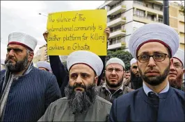  ?? BILAL HUSSEIN / AP ?? In front of the Russian embassy in Beirut, Lebanese Sunni clerics protest Sunday in solidarity with residents of the Syrian capital’s eastern suburb of Ghouta. The Syrian capital and its embattled suburbs were relatively calm Sunday.