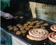  ??  ?? Chef Jesse Vallins of the Maple Leaf Tavern grilled up a bunch of his homemade sausages, above. Left, grilled skirt steak with charred beans, chilies, bone marrow and chimichurr­i were available from Richmond Station.