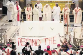  ?? GREGORIO BORGIA AP ?? Protesters display a banner and interrupt Pope Francis’ Mass at the National Shrine of Saint Anne de Beaupre in Quebec City, Canada, on Thursday.