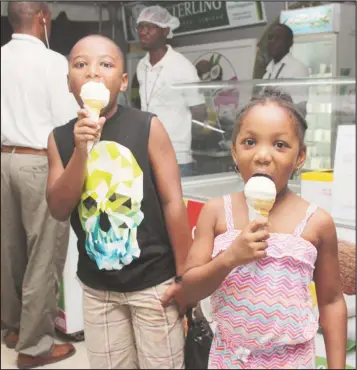  ??  ?? Young patrons sampling the coconut ice cream that was available at the Sterling booth