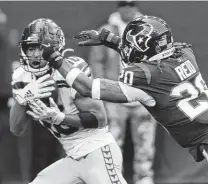  ?? ?? Seahawks receiver Tyler Lockett hauls in a 55-yard touchdown reception past Texans safety Justin Reid on Sunday.